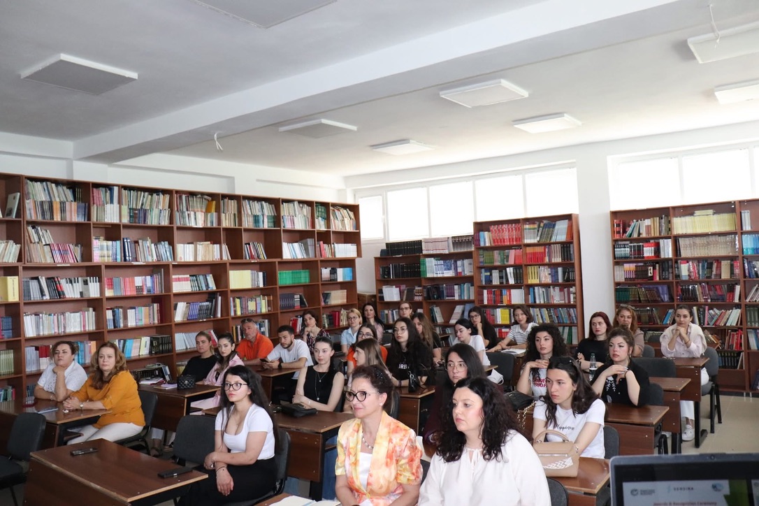 Students and faculty attending a Democracy Discourse Index session in the university library in Korçë, Albania